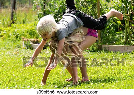 Stock Photograph - Children playing in garden. Fotosearch