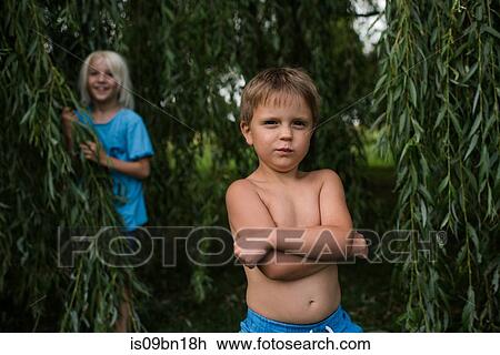 Stock Image - Children playing under willow tree. Fotosearch