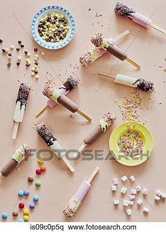 Chocolate top ice lollies and sprinkles on table View Large Photo Image Stock Photography - Chocolate top ice lollies and sprinkles on table. Fotosearch