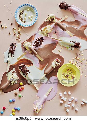 Chocolate top ice lollies melting and sprinkles on table View Large Photo Image Stock Photography - Chocolate top ice lollies melting and sprinkles on table. Fotosearch