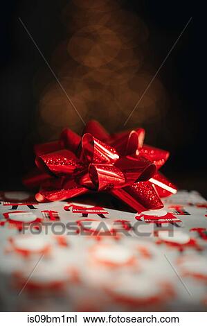 Christmas present with red bow View Large Photo Image Stock Image - Christmas present with red bow. Fotosearch