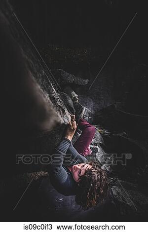 Stock Image - Climber bouldering in forest, Squamish, Canada. Fotosearch
