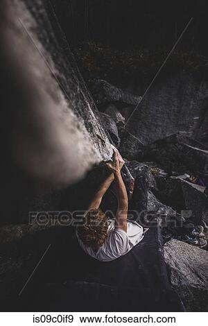 Stock Photo - Climber bouldering in forest, Squamish, Canada. Fotosearch