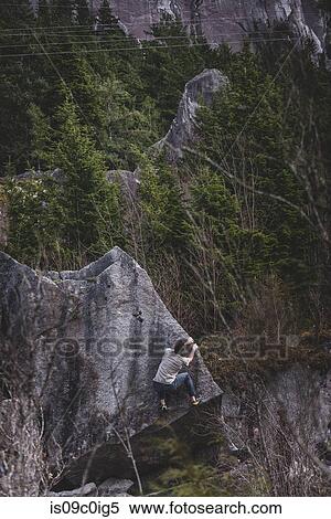 Stock Photography - Climber bouldering in forest, Squamish, Canada. Fotosearch