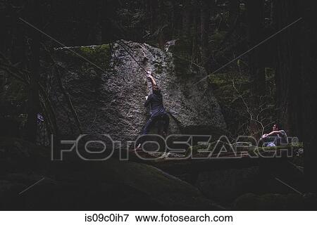 Climber bouldering, watched by friend, Squamish, Canada View Large Photo Image Stock Photo - Climber bouldering, watched by friend, Squamish, Canada. Fotosearch