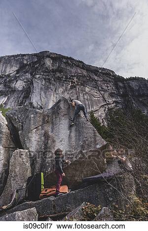 Climber bouldering, watched by friends, Squamish, Canada View Large Photo Image Stock Photo - Climber bouldering, watched by friends, Squamish, Canada. Fotosearch