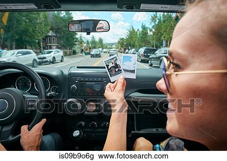 Close up of young woman on road trip holding instant photograph, Breckenridge, Colorado, USA View Large Photo Image Stock Image - Close up of young woman on road trip holding instant photograph, Breckenridge, Colorado, USA. Fotosearch