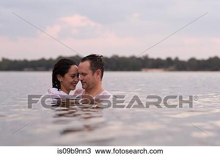 Stock Image - Clothed couple in water, Destin, Florida, United States, North America. Fotosearch