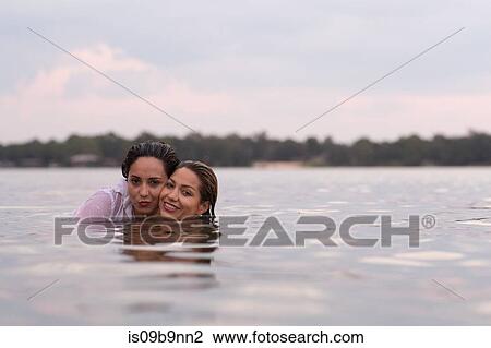 Stock Image - Clothed friends in water, Destin, Florida, United States, North America. Fotosearch