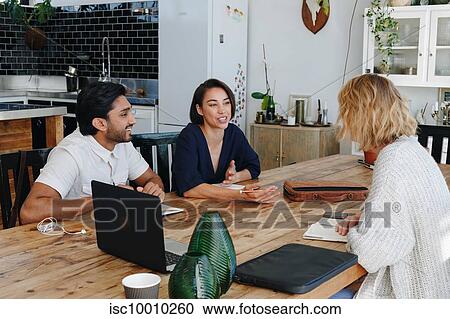 Colleagues having discussion in office View Large Photo Image Stock Image - Colleagues having discussion in office. Fotosearch