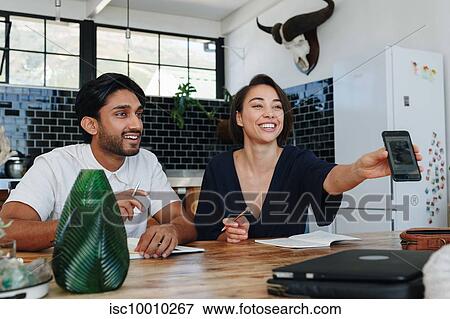 Colleagues having discussion in office View Large Photo Image Stock Photo - Colleagues having discussion in office. Fotosearch