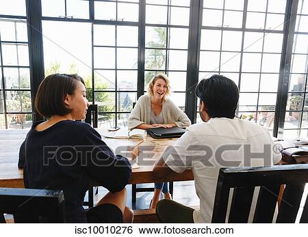 Colleagues having discussion in office View Large Photo Image Stock Photograph - Colleagues having discussion in office. Fotosearch