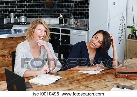Colleagues having discussion in office View Large Photo Image Stock Photograph - Colleagues having discussion in office. Fotosearch