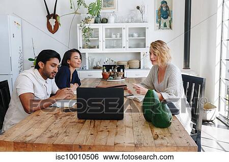 Colleagues having discussion in office View Large Photo Image Stock Photograph - Colleagues having discussion in office. Fotosearch