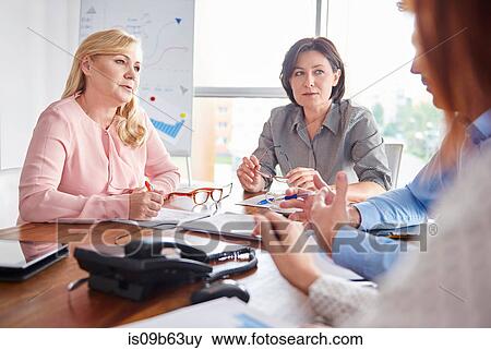 Colleagues having discussion in business meeting View Large Photo Image Stock Photo - Colleagues having discussion in business meeting. Fotosearch
