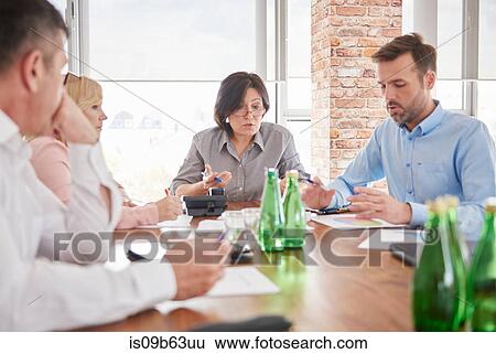 Colleagues having discussion in business meeting View Large Photo Image Stock Photograph - Colleagues having discussion in business meeting. Fotosearch