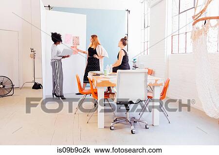 Colleagues in creative studio discussing swatches View Large Photo Image Stock Image - Colleagues in creative studio discussing swatches. Fotosearch