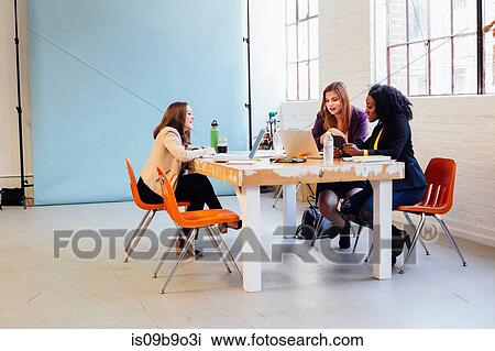 Colleagues in industrial office building working at desk View Large Photo Image Stock Image - Colleagues in industrial office building working at desk. Fotosearch