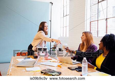 Colleagues in industrial office building working at desk View Large Photo Image Stock Photo - Colleagues in industrial office building working at desk. Fotosearch