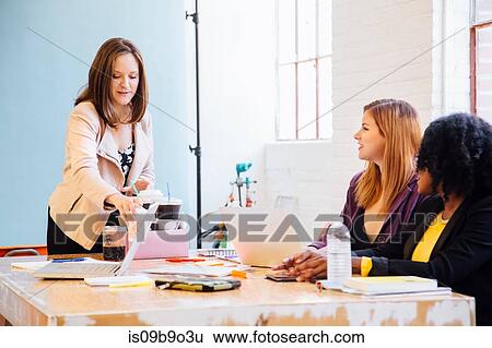 Colleagues in industrial office building working at desk View Large Photo Image Stock Photograph - Colleagues in industrial office building working at desk. Fotosearch