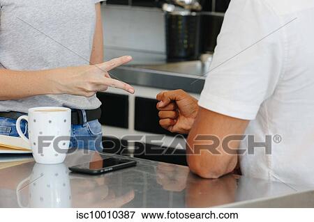 Colleagues playing rock-paper-scissors at coffee break in pantry View Large Photo Image Stock Photo - Colleagues playing rock-paper-scissors at coffee break in pantry. Fotosearch