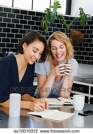 Colleagues talking and working at coffee break in pantry View Large Photo Image Stock Image - Colleagues talking and working at coffee break in pantry. Fotosearch