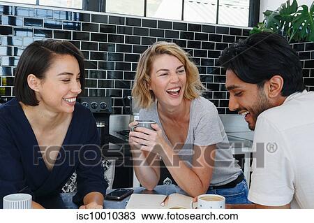 Colleagues talking and working at coffee break in pantry View Large Photo Image Stock Image - Colleagues talking and working at coffee break in pantry. Fotosearch