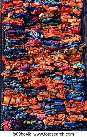 Colourful stacked migrant lifejackets exhibition - Soleil Levant by Chinese artist Ai Weiwei, Nyhavn, Copenhagen, Denmark View Large Photo Image Stock Image - Colourful stacked migrant lifejackets exhibition - Soleil Levant by Chinese artist Ai Weiwei, Nyhavn, Copenhagen, Denmark. Fotosearch