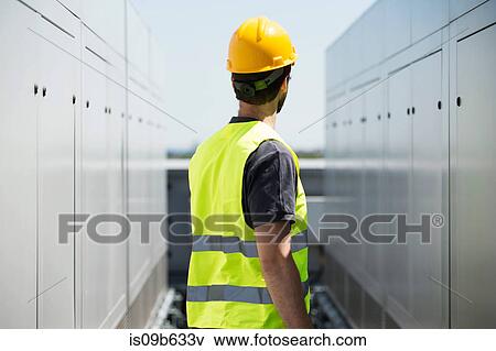 Construction worker, wearing hard hat and hi vis vest, outdoors, rear view View Large Photo Image Stock Photo - Construction worker, wearing hard hat and hi vis vest, outdoors, rear view. Fotosearch