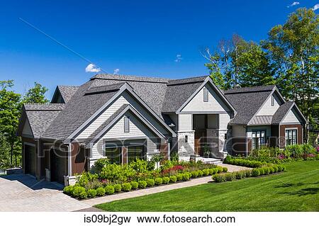 Contemporary natural stone and wood luxurious bungalow style home facade View Large Photo Image Stock Photo - Contemporary natural stone and wood luxurious bungalow style home facade. Fotosearch