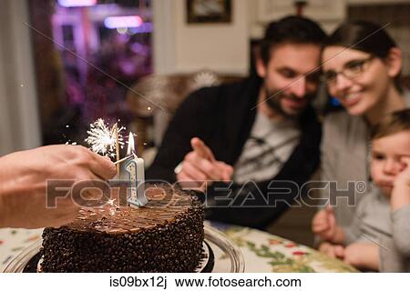 Couple and baby boy with first birthday cake View Large Photo Image Stock Image - Couple and baby boy with first birthday cake. Fotosearch