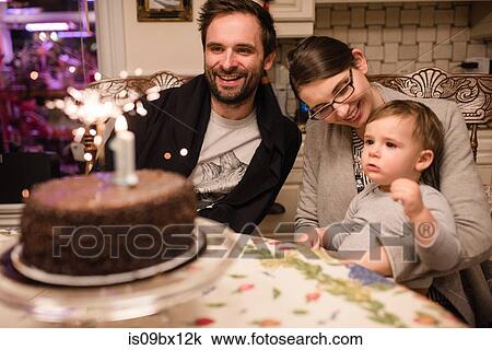 Couple and baby boy with first birthday cake View Large Photo Image Stock Image - Couple and baby boy with first birthday cake. Fotosearch