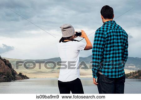 Couple beside Dillon Reservoir, taking photograph, rear view, Silverthorne, Colorado, USA View Large Photo Image Stock Photo - Couple beside Dillon Reservoir, taking photograph, rear view, Silverthorne, Colorado, USA. Fotosearch