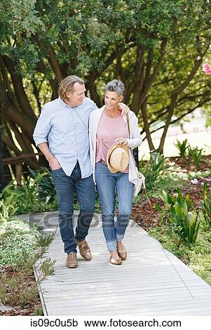 Couple enjoying walk on garden path, Cape Town, South Africa View Large Photo Image Stock Image - Couple enjoying walk on garden path, Cape Town, South Africa. Fotosearch