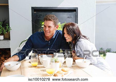 Couple having lunch and smiling at home View Large Photo Image Stock Photo - Couple having lunch and smiling at home. Fotosearch