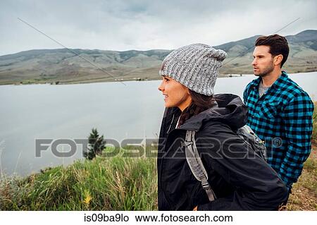 Couple hiking, standing beside Dillon Reservoir, looking at view, Silverthorne, Colorado, USA View Large Photo Image Picture - Couple hiking, standing beside Dillon Reservoir, looking at view, Silverthorne, Colorado, USA. Fotosearch