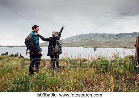 Stock Photograph - Couple hiking, standing beside Dillon Reservoir, Silverthorne, Colorado, USA. Fotosearch