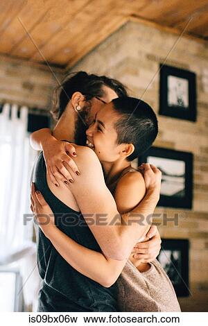 Stock Photo - Couple hugging at home. Fotosearch
