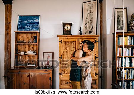 Couple hugging at home View Large Photo Image Stock Photography - Couple hugging at home. Fotosearch