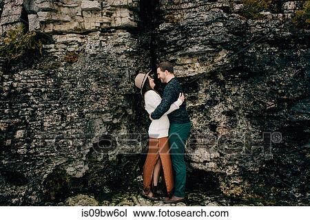 Couple hugging beside rock face, Tobermory, Canada View Large Photo Image Stock Image - Couple hugging beside rock face, Tobermory, Canada. Fotosearch