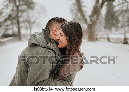 Couple hugging in snowy landscape, Georgetown, Canada View Large Photo Image Picture - Couple hugging in snowy landscape, Georgetown, Canada. Fotosearch