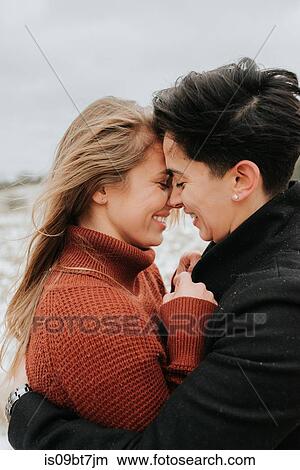 Picture - Couple hugging in snowy landscape, Georgetown, Canada. Fotosearch