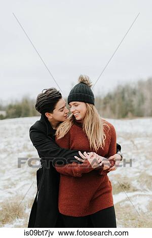 Stock Photo - Couple hugging in snowy landscape, Georgetown, Canada. Fotosearch