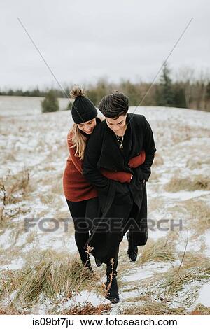 Stock Photograph - Couple hugging in snowy landscape, Georgetown, Canada. Fotosearch
