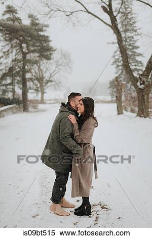 Stock Photography - Couple hugging in snowy landscape, Georgetown, Canada. Fotosearch