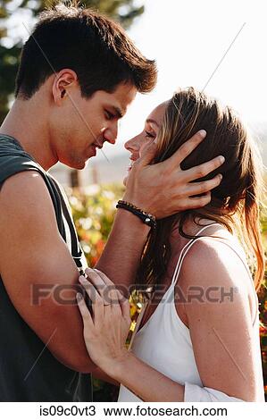 Stock Image - Couple hugging in vineyard, Cape Town, South Africa. Fotosearch