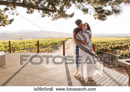 Couple hugging in vineyard, Cape Town, South Africa View Large Photo Image Stock Photograph - Couple hugging in vineyard, Cape Town, South Africa. Fotosearch