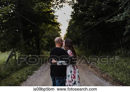 Couple hugging on countryside road View Large Photo Image Picture - Couple hugging on countryside road. Fotosearch