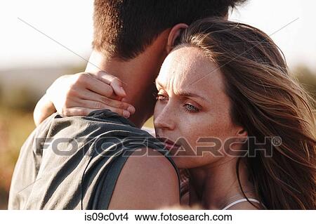 Couple hugging, woman looking worried View Large Photo Image Picture - Couple hugging, woman looking worried. Fotosearch