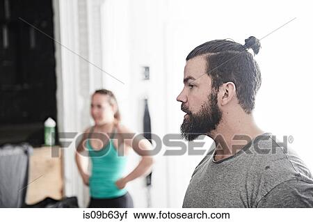 Stock Image - Couple in cross training gym. Fotosearch